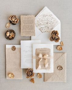 the wedding stationery is laid out on top of each other