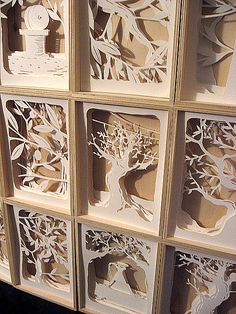 paper cut trees are arranged on the wall