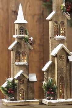 two small wooden buildings decorated with christmas decorations