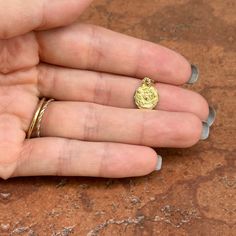 14KT yellow gold raised design infant baptism round medal pendant charm. Makes a wonderful baptism gift! Length: 18mm including bail Width: 10mm Weight: .80 grams Stamped 14K Diamond-cut raised design No chain included Gold Coin Pendant Charms, Tarnish Resistant Gold Plated Round Pendant Charms, Round Coin Pendant Charms As Gifts, Coin Pendant Round Charms For Gift, Coin Pendant Charms As Gift, Coin Pendant Charms For Gifts, 14k Gold Miraculous Medal Jewelry, Gold Round Pendant Charms That Are Tarnish Resistant, Gold Tarnish-resistant Round Pendant Charm