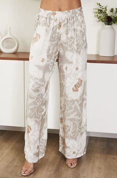 Beautiful flowing beige Ikat print pant made from soft viscose fabric. Floral Print Wide Leg Bottoms In Viscose, Bohemian Style Cream Bottoms With Elastic Waistband, Chic Cream Floral Print Bottoms, Printed Wide-leg Rayon Bottoms, Printed Rayon Wide-leg Pants, Printed Rayon Long Pants, Chic Printed Bottoms With Relaxed Fit, Chic Printed Pants For Loungewear, Beige Harem Pants For Spring Loungewear