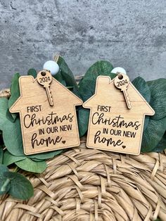 two wooden christmas tags with the words first christmas in our new home