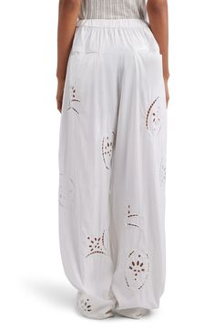 Breezy relaxed-fit pants cinched with a simple drawstring are embroidered with airy sprigs of eyelet for a beach-ready look. 31" inseam; 16" leg opening; 13" front rise; 15 1/2" back rise (size 40FR) Zip fly with hook-and-bar closure Drawstring waist Side-seam pockets; back welt pockets 82% lyocell, 18% polyamide Dry clean Imported Designer Clothing White Bohemian Bottoms With Drawstring, Bohemian White Drawstring Bottoms, Breezy White Bottoms With Relaxed Fit, White Floral Embroidered Wide-leg Bottoms, White Wide-leg Pants With Floral Embroidery, White Breezy Cotton Bottoms, Casual Floral Embroidered Bottoms For Vacation, Casual Floral Embroidery Bottoms For Vacation, Casual Vacation Bottoms With Floral Embroidery