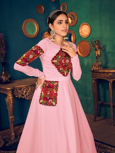 Look pretty adorning this pink color Anarkali gown in georgette material embellished with gamthi embroidery, mirror, and pearl work.
The gown comes with crepe inner material. 
The pink gown is semi-stitched can be customized up to 42 inches and the gown length is 58 inches. 
Pink color gown with gamthi work look amazing traditional can be worn at festivals like Navratri.
Disclaimer: This gown will not come with a can-can, bottom, and dupatta. Embellished Anarkali Gown For Traditional Ceremonies, Semi-stitched Georgette Dress With Embroidered Border, Georgette Dresses With Embroidered Border For Navratri, Anarkali Gown With Mirror Work For Traditional Ceremonies, Navratri Georgette Dress With Embroidered Border, Pink Embroidered Dress For Traditional Ceremonies, Floor-length Anarkali Set With Mirror Work For Traditional Ceremonies, Mirror Work Gown For Eid, Mirror Work Gown For Eid Ceremonies