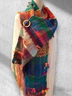 a multicolored scarf is hanging on a mannequin