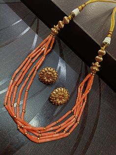 Discover the timeless elegance of our Antique Coral Beads Necklace, the perfect addition to any jewelry collection. Handcrafted with the finest materials, this necklace features the latest Indian jewelry design, showcasing the intricate craftsmanship and beauty of Indian culture. Elevate your style with this stunning piece, a must-have for any jewelry enthusiast. Indian Coral Jewellery Gold, Luxury Beaded Necklace With Gold Beads, Long Necklace With Gold Beads For Jewelry Making, Elegant Multi-strand Gold Beads, Elegant Orange Polished Beads Jewelry, Elegant Orange Beaded Necklaces With Gemstone Beads, Elegant Necklaces With Gold Beads For Celebration, Elegant Orange Gemstone Beads Necklace, Elegant Orange Necklaces With Polished Beads