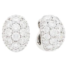 Graff Pair of White Gold and Diamond Dome Ear-clips This pair of earrings are oval domes of 48 round diamonds approx. 16.20 carats., edged by 64 small round diamonds approx. 1.75 carats all set in 18k white gold and clip-backs with collapsible posts, Signed Graff. With signed pouch. Measurements: ⅞ x 5/8 inch. Luxury White Clip-on Diamond Earrings, Luxury Oval Diamond White Diamond Earrings, Luxury Oval Diamond Earrings With Pave Setting, White Round Clip-on Diamond Earrings, Classic Diamond Clip-on Earrings With Brilliant Cut, White Diamond Clip-on Earrings, Luxury Oval Clip-on Earrings For Anniversary, Diamond Clip-on Earrings With Brilliant Cut, Luxury Round Clip-on Diamond Earrings