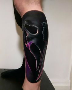 a man's leg with a black and purple mask on top of his leg