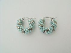 "This pair of beaded hoop earrings were woven with tiny sea foam green and silver glass beads.  The beads were weaved onto tarnish resistant stainless steel latch style hoops. Finished hoops measure:  .75\" of an inch across the widest part of the earrings ( i.905 cm ) outside diameter. https://www.etsy.com/shop/FMGuyDesigns" Silver Beaded Earrings With Tiny Round Beads, Handmade Silver Small Hoop Beaded Earrings, Small Silver Hoop Earrings With Tiny Beads, Silver Small Hoop Earrings With Tiny Beads, Handmade Silver Beaded Small Hoop Earrings, Silver Beaded Round Hoop Earrings, Silver Hoop Earrings With Tiny Beads, Bohemian Green Small Hoop Beaded Earrings, Summer Beaded Green Hoop Earrings