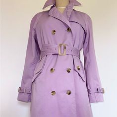 Gorgeous Isaac Mizrahi Lavender Color Classic Trench Coat, With Beautiful Taupe Tortoise Swirl Isaac Mizrahi Imprinted Buttons. Belt Buckle Is Also Taupe Swirl And Beautiful. Excellent Tailoring Complete In Sleeves And Pockets Belt Secured - By Buttoned Bands Very Flattering Fit On Shoulders And Overall No Detail Forgotten Barbie Wardrobe Pick!! Size S 37.5” Long, Top To Bottom 16” Sleeve Length From Armpit 55% Cotton 45% Polyester Lined Sleeves Never Used - New A Standout! Elegant Lavender Outerwear For Spring, Spring Purple Outerwear For Work, Chic Purple Outerwear For Spring, Chic Purple Outerwear For Work, Chic Lavender Outerwear For Workwear, Chic Lavender Outerwear For Work, Purple Double-breasted Spring Outerwear, Purple Double-breasted Outerwear For Spring, Classic Purple Outerwear For Work