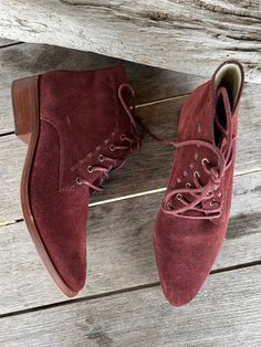 Wine red suede lace up booties with a western feel. little lace through leather detail and leather stacked heel. Leather lining. Leather outsole Size 7 Fall Lace-up Boots With Suede Lining, Burgundy Lace-up Boots For Fall, Burgundy Lace-up Boots With Round Toe For Fall, Suede Lace-up Boots With Stacked Heel, Western Ankle Lace-up Boots With Leather Sole, Burgundy Leather Lace-up Boots, Ankle-high Lace-up Boots With Suede Lining For Fall, Fall Lace-up Boots With Stacked Heel, Burgundy Almond Toe Boots For Fall