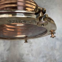 a close up view of the inside of an antique light fixture with brass fittings