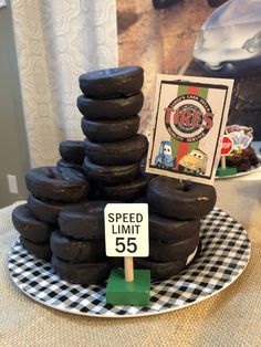 a stack of chocolate donuts sitting on top of a table