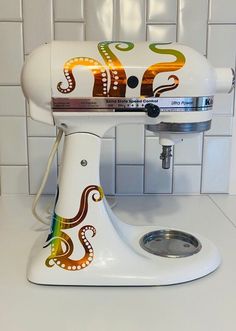 a white mixer sitting on top of a counter