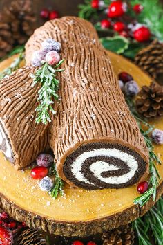 a log cake decorated with icing and pine cones