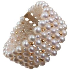 This timeless bracelet has an elegant pearl weave. At 1.25 inches wide the different size pearls create a checkered design with the 14 k yellow gold plated faceted beads. The bracelet is 7.25 inches and fits comfortably on the wrist like a band. The sliding clasp is also 14 k yellow gold plated sterling silver. It is easy to use and secure once fitted on the wrist. This classic design was created with carefully hand-selected pearl and beads by Marina J. The bracelet is luxurious and fits gracefu Egyptian Bracelet, Vintage Beaded Bracelet, Garnet Bead Bracelet, Pearl Bracelet Gold, White Pearl Bracelet, Silver Ring Designs, Modern Bracelets, Woven Bracelet, Gold Plated Bracelets