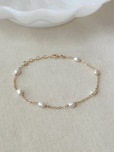 Please review the bracelet sizing guide below for the perfect fit! This dainty natural Pearl bracelet looks perfect for special occasions or can elevate any casual outfit. Each Pearl is hand wrapped skin friendly 14K Gold Filled or 925 Sterling Silver. Every bracelet comes with a small extender for adjustable sizing. You will feel sophisticated and chic when you put it on! * 4-5mm Freshwater Pearls * Pearl shape: round to oval, semi-irregular, semi-flat baroque * Dainty 14K Gold Filled Chain or Delicate Oyster Bracelet Jewelry For Wedding, Delicate Oyster Bracelet For Weddings, Delicate Wedding Jewelry With Oyster Bracelet, Minimalist Oyster Bracelet Jewelry For Wedding, Minimalist Wedding Jewelry With Oyster Bracelet, Adjustable Delicate Chain Gold Bracelet For Wedding, Adjustable Gold Bracelet For Wedding, Classic Delicate Chain Bracelet For Anniversary, Gold Bracelet With Adjustable Chain For Wedding