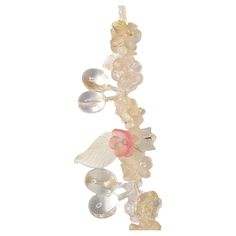 With a silver clasp that could be as old as the Victorian period and in an Art-Nouveau style with pale intricate flora motifs, this antique long glass necklace features lampwork-like hand-pressed glass that realizes pink, frosted and clear flowers, leaves, and cherries in nine stations strung along most of the lower necklace. The semi-transparent and reflective beads of various sizes and depth on the necklace, many of which are intermittently clustered via multiple darkened brass pins that each Brass Pins, Victorian Period, Unique Costumes, Brass Pin, Organic Matter, Semi Transparent, Flowers Leaves, Pressed Glass, Glass Necklace