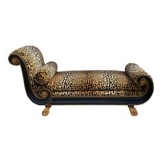 a leopard print chaise lounge chair with gold trimmings and black velvet upholster