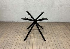 a black table sitting on top of a wooden floor