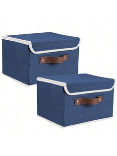 two blue storage boxes with leather handles