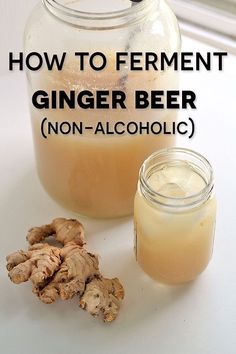 a glass jar filled with ginger beer next to some ginger root