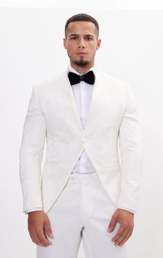 DETAILS This white tailored fit tuxedo is a unique and stylish option for any special or formal event. Features a raised laced texture of the fabric that creates depth and dimension, adding a tactile element to the jacket. Designed with a mandarin collar. which adds a touch of modernity to the jacket. As well as having a satin finish around the closure, giving a luxurious sheen to the outfit. Pair with any Tomson Tuxedo Pants SIZE + FIT Tailored fit, to find your correct size use the ''What's my Luxury White Suit For Evening, Luxury White Evening Suit, Luxury White Evening Tuxedo, White Tuxedo Blazer For Evening, White Fitted Tuxedo With Notch Lapel, Elegant Tailored White Tuxedo, Luxury White Suit For Parties, Elegant White Tailored Tuxedo, White Fitted Tuxedo For Semi-formal Occasions