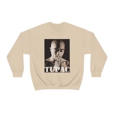 Tupac Shakur Pullover Sweater Ideal for any situation, a unisex heavy blend crewneck sweatshirt is pure comfort. These garments are made from polyester and cotton. This combination helps designs come out looking fresh and beautiful. The collar is ribbed knit, so it retains its shape even after washing. There are no itchy side seams on these sweaters. .: 50% cotton, 50% polyester .: Medium-heavy fabric (8.0 oz/yd² (271.25 g/m .: Loose fit .: Sewn-in label .: Runs true to size Relaxed Fit Fleece T-shirt For Streetwear, Streetwear Fleece T-shirt With Ribbed Cuffs, Fleece T-shirt For Streetwear, Heavyweight Sweatshirt For Fall Streetwear, Heavyweight Urban Sweatshirt For Fall, Urban Heavyweight Sweatshirt For Fall, Heavyweight Letter Print Sweatshirt For Fall, Urban Style T-shirt With Ribbed Cuffs For Fall, Heavyweight Crew Neck Sweatshirt For Fall