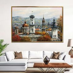 a painting hanging on the wall above a couch in a living room with a white sofa and coffee table