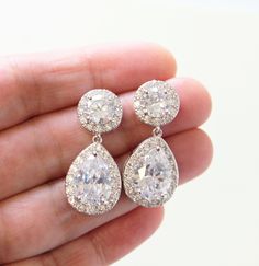 Vintage style zircon earrings  Colour: rhodium(silver tone) /clear Measurements: approx 3.4 cm x 14 mm including studs(small and delicate).  Materials: rhodium components, zircon crystals . Stud earrings. Great for wedding or other celebration. SAME STYLE in gold: https://www.etsy.com/uk/listing/631042996/gold-bridal-earrings-art-deco-earrings?ref=shop_home_active_7 SAME STYLE in rose gold: https://www.etsy.com/uk/listing/631044362/rose-gold-bridal-earrings-art-deco?ref=related-5 MORE SAME STYLE Crystal Drop Earrings Wedding, Art Deco Earrings Vintage, Wedding Earrings Vintage, Drop Earrings Wedding, Bridesmaid Pearl Earrings, Silver Bridal Earrings, Dangle Earrings Wedding, Crystal Teardrop Earrings, Bridesmaid Pearls