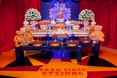 there are many teddy bears sitting on the table with food in front of them and decorations around it