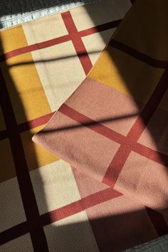 an image of a checkered table cloth with the shadow of a person's hand on it