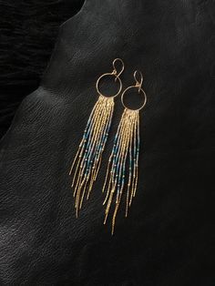 "Maui Swan Designs beautiful, glamorous long Glass Beadwork and handmade 14K gold filled Hoop Earrings with 14K gold filled chain fringe. Indigenous inspired glass seed bead earrings. Original design using tiny Czech glass seed beads hand sewn beautifully together with 14K gold filled chain and handmade Hoop, silver lined glass seed beads, 14K gold filled twisted buggle beads & nylon thread coated in Maui beeswax to maintain strength. 5\" long delicate earrings incorporating tones of gold , Elegant Blue Fringe Jewelry, Blue Long Drop Tassel Jewelry, Dangle Beaded Earrings With 14k Gold Filled, Blue Long Drop Jewelry With Beaded Fringe, Bohemian 14k Gold Filled Beaded Dangle Earrings, Bohemian 14k Gold-filled Beaded Dangle Earrings, 14k Gold-filled Dangle Beaded Earrings With Gold Beads, Bohemian 14k Gold Filled Beaded Earrings, Bohemian 14k Gold-filled Beaded Earrings