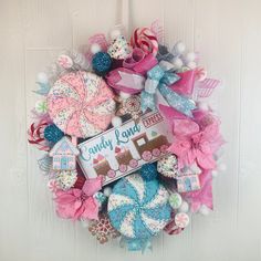 a wreath with candy land on it hanging on the front door for someone's birthday