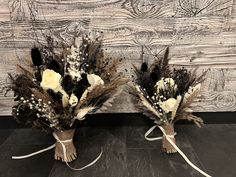 two bouquets of dried flowers tied to each other