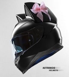 a motorcycle helmet with a pink bow on it