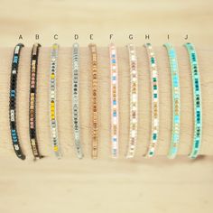 the bracelets are lined up on top of each other in different colors and sizes