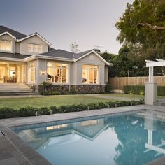 a house with a pool in front of it