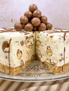 a cake with chocolate and white frosting on top sitting on a glass platter