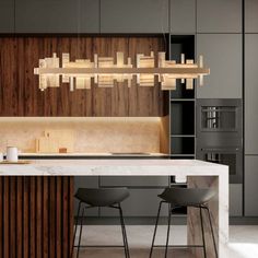 a modern kitchen with marble counter tops and bar stools, along with wooden cabinets