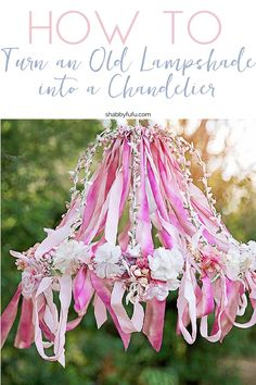 pink and white flowers hanging from a chandelier