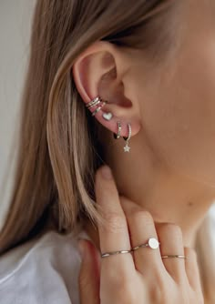 These are sterling silver huggie earrings which feature a tiny star pendant hanging from them and which are embellished with tiny zircon stones--11 on the front of the earring and six on the star pendant. A hinged opening and thin earpiece make them easy to put on and take off, and their small circumference means they fit snugly around the earlobe. This is a delicate and stylish pair of earrings that will take you through from day to night. Details  Diameter: 0.9 cm Weight: 1.0 g Material: 925 S Huggie Earrings Silver, Sterling Silver Hoop Earrings, Huggie Earrings, Heart Earrings Studs, Sterling Silver Hoops, Earrings Sterling Silver, Star Pendant, Sterling Silver Earrings Studs, Silver Rose Gold