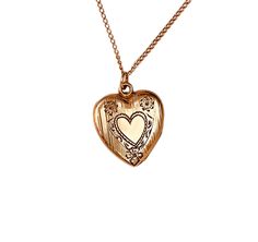 Vintage 1940s gold filled heart locket with etched heart and floral engraved.  The locket opens with ease and closes with a strong snap.  The locket is marked P&K on the inner frame.  This would make a fantastic addition to any jewelry collection. Locket measures 7/8" X 3/4" from the top of its original bale. Weight: 3.85 grams A condition is excellent, with no damages or repairs. The business American Queen Pitman & Keeler was based in Attelboro, MA and they were in business from approximately Vintage 14k Gold Locket Necklace, Vintage 14k Gold Locket Necklace Stamped 14k, Vintage Gold Locket Necklace Stamped 14k, Vintage 14k Stamped Locket Necklace For Formal Occasions, Vintage 14k Stamped Locket Necklace For Formal Events, Vintage Engraved Rose Gold Jewelry, Vintage Etched Rose Gold Jewelry, Vintage Rose Gold Etched Jewelry, Vintage Heart Charm Medallion Jewelry