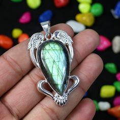 DESCRIPTION Gemstone Name : Natural Labradorite Shape : Pear Shape Length : 1.75 Inch (approx.) Materials: 925 Silver Plated/Gemstone Style : Necklace Pendant Country/Region of Manufacture : India Made In : Jaipur Rajasthan  https://www.etsy.com/in-en/shop/MadinaJewelz?ref=seller-platform-mcnav The pictures shown are of the actual product that you will receive. Please note stone colors may look slightly different depending on your monitor calibration. All stones are natural, so little imperfecti Silver Gemstone Cabochons For Gifts, Cabochon Labradorite Gemstones Gift, Labradorite Cabochon Gemstones For Gifts, Bohemian Jewelry With Bezel Setting For Gift, Bohemian Jewelry With Bezel Setting As Gift, Labradorite Jewelry With Bezel Setting As Gift, Labradorite Jewelry With Bezel Setting For Gift, Silver Gemstone Beads For Jewelry Making, Artisan Beads And Cabochons Pendant For Gift