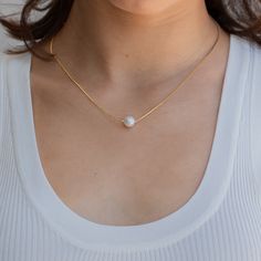 K E N N E D Y ∙ P E A R L ∙ N E C K L A C E Our romantic and dainty pearl pendant necklace adds a touch of minimalist glamour to your everyday jewelry look. Whether you want to add a polished effect to a causal outfit or wear as delicate wedding jewelry, this necklace has you covered. * Material: High Quality Solid 925 Sterling Silver, Freshwater Pearl. * Finish: Sterling Silver ∙ 18K Gold * Featuring a dainty 6mm Round Pearl Charm with adjustable box chain 16 inches to 18 inches. H O W ∙ T O ∙ Minimalist Pearl Charm Necklace For Anniversary, White Solitaire Necklace With Delicate Chain For Anniversary, Anniversary White Solitaire Necklace With Delicate Chain, Minimalist Pearl White Round Pendant Necklace, Minimalist Pearl Pendant Charm Necklace For Anniversary, Minimalist Pearl Necklace With Round Pendant, Minimalist Pearl White Necklace With Delicate Chain, Minimalist Solitaire Pendant Necklace For Wedding, Minimalist White Solitaire Necklace As A Gift