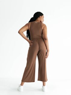 The Hana Jumpsuit is the ultimate done-in-one outfit. With its compressive bodice, high wasted culotte pant, and deep side seam pockets, it’s designed to be effortlessly elegant while simultaneously maximizing your comfort level. Wear it as is to a dance class, or to walk to the park. Or layer it with your favorite little cardigan and a hat to head out for the day. And its versatility doesn’t stop there — you can rock it with your favorite comfy heels for a night out. We aren’t exaggerating when Versatile Cropped Bottoms For Loungewear, Wide Leg Stretch Jumpsuits And Rompers For Loungewear, Stretch Wide Leg Jumpsuits For Loungewear, Solid Cropped Pants For Loungewear, Solid Cropped Loungewear Pants, Versatile Wide Leg Jumpsuit Or Romper, Compressive Solid Bottoms For Workwear, Solid Stretch High-waisted Jumpsuits And Rompers, Solid Color Wide Leg Jumpsuits And Rompers For Loungewear