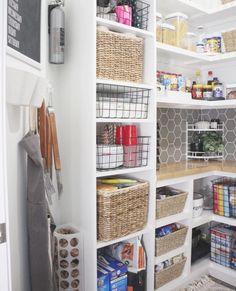 the pantry is organized with baskets and other items to keep things organized on shelves in order