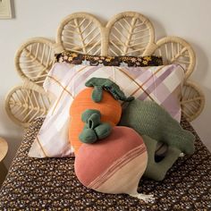 a bed topped with pillows and stuffed animals