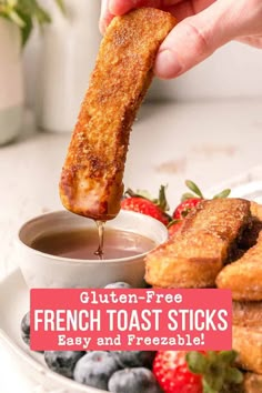 a person dipping french toast sticks into a bowl of fruit and sauce with the words gluten - free french toast sticks easy and freezeable