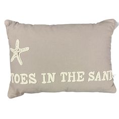 a pillow that says toes in the sand with a starfish on it and an embroidered message